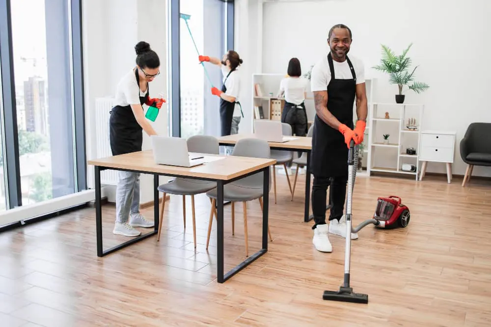 Cleaning team working through a meeting room