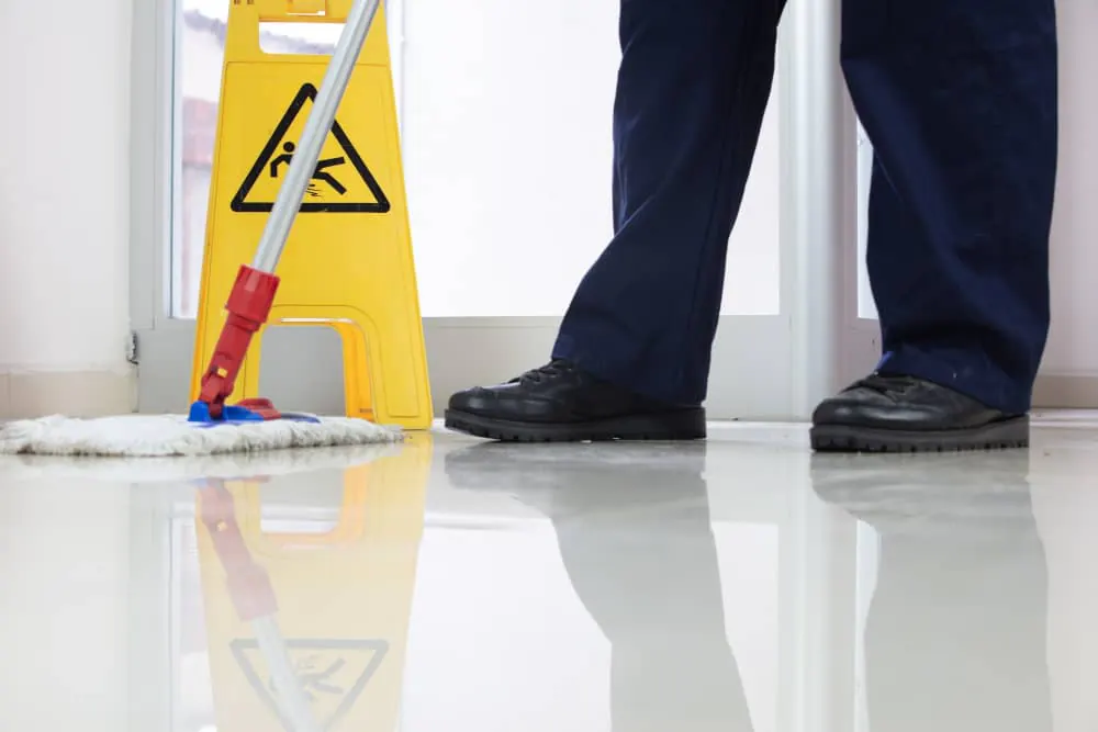 Wet floor sign standing on a freshly mopped corridor